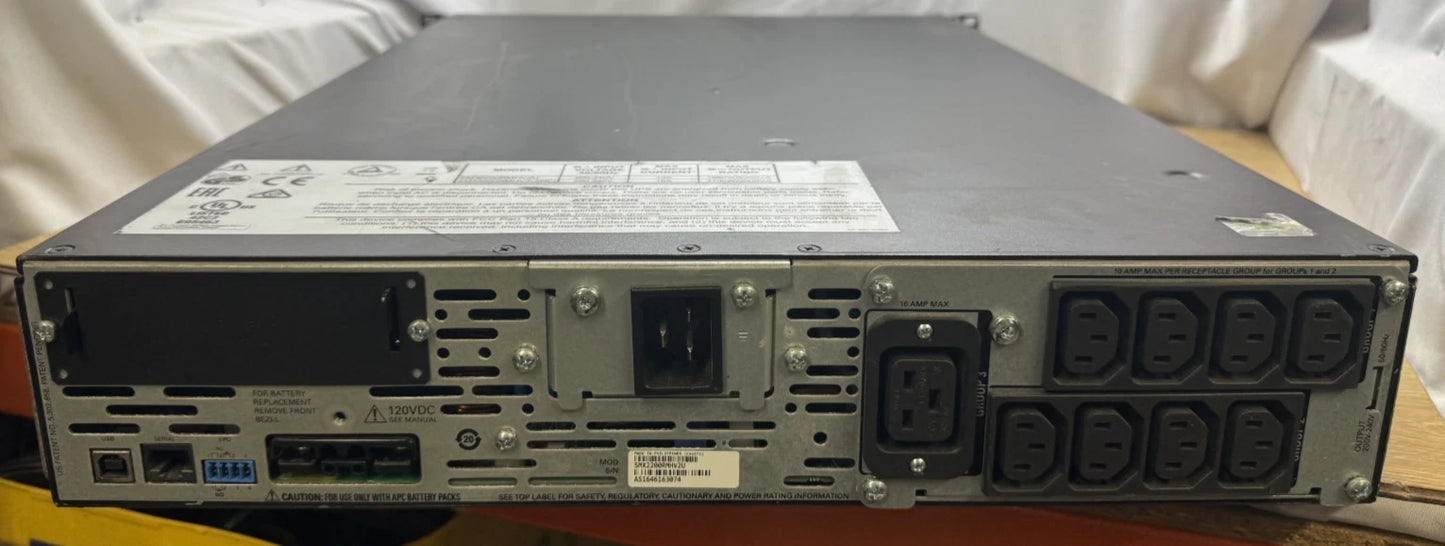 Back view of a server with multiple power connectors on a wooden surface.