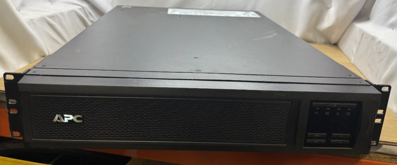 APC server rackmount on a wooden surface with a white curtain background