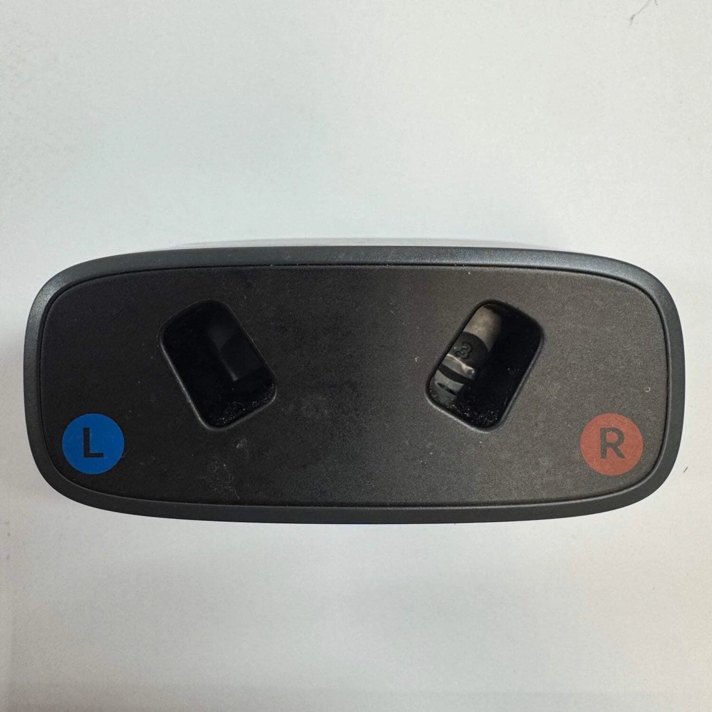 A black plastic dual-channel audio jack cover with blue 'L' and red 'R' indicator circles on a white background.