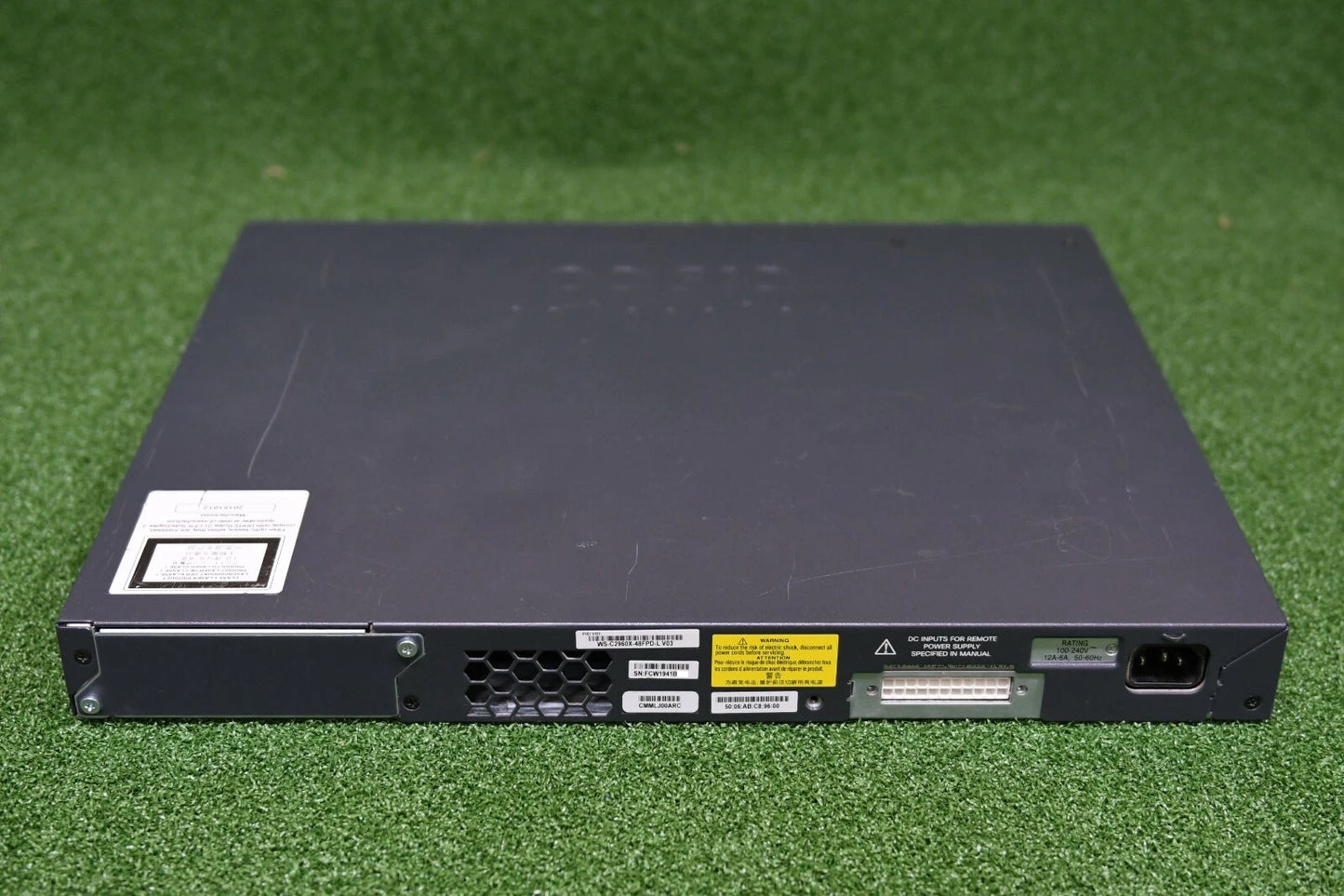 Black electronic device on a green grass background